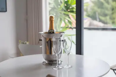 a bottle of champagne in a bucket on a table at Sunflower Luxury Loft w AC Downtown and Metro in Porto