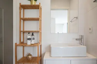 a bathroom with a sink and a mirror at Sunflower Luxury Loft w AC Downtown and Metro in Porto