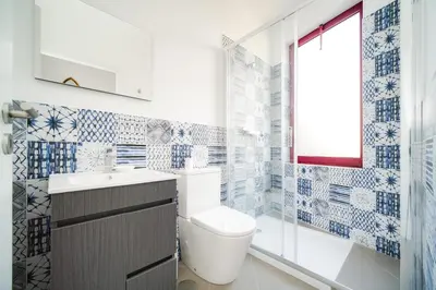 a bathroom with a toilet and a sink and a shower at Nomad's Fine Arts Collection in Porto