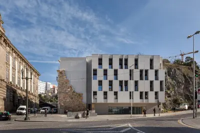 a building on a street with people walking around it at S.Bento Residences in Porto