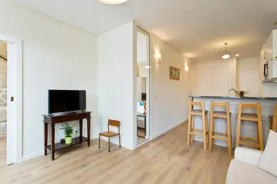 a living room with a bar and a kitchen at Estrela de Gaia Apartments in Vila Nova de Gaia