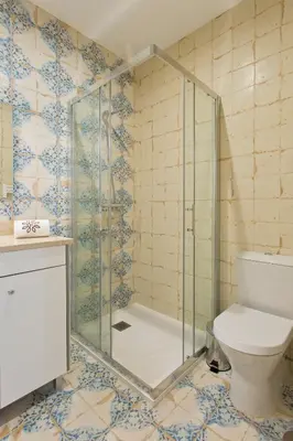 a bathroom with a glass shower and a toilet at Estrela de Gaia Apartments in Vila Nova de Gaia