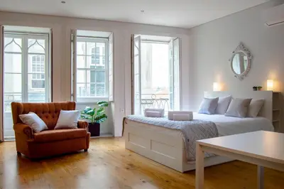 a bedroom with a bed and a chair at Old City Oporto in Porto