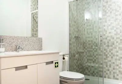 a bathroom with a toilet and a glass shower at Old City Oporto in Porto