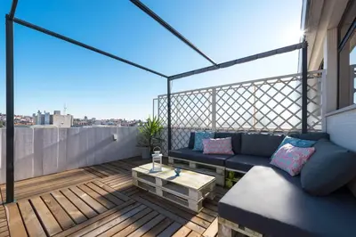 a patio with a couch and a table on a balcony at Oporto Dinis Apartment - Rooftop in Porto