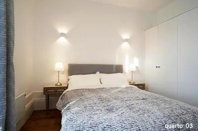 a bedroom with a large bed with two night stands at Santa Catarina Guest House (Porto city center) in Porto