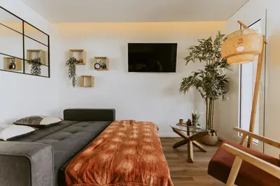a bedroom with a bed and a tv on the wall at Bruval Premium Apartments - Gaia in Vila Nova de Gaia