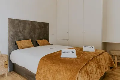a bedroom with a bed with two scales on it at Bruval Premium Apartments - Gaia in Vila Nova de Gaia