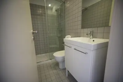 a bathroom with a sink and a toilet and a shower at Oporto Cool - Praça da Batalha in Porto