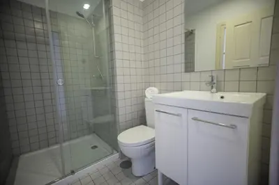 a bathroom with a toilet and a sink and a shower at Oporto Cool - Praça da Batalha in Porto