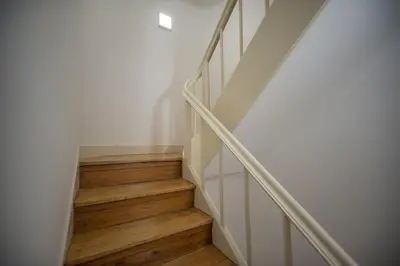 a staircase with wooden floors and white walls at Oporto Cool - Praça da Batalha in Porto