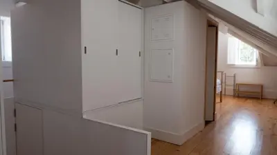 a white staircase in a white room with a window at APOSENTUS - Architect and design apartment in Porto