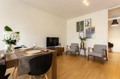 a living room with a dining room table and chairs at APOSENTUS - Elegant Functionality Porto Downtown in Porto