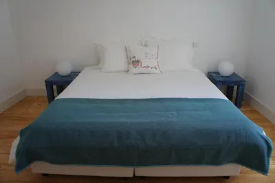 a bedroom with a large bed with two night stands at Alfandega Apartments in Porto