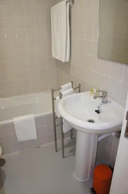 a bathroom with a sink and a bath tub at Alfandega Apartments in Porto