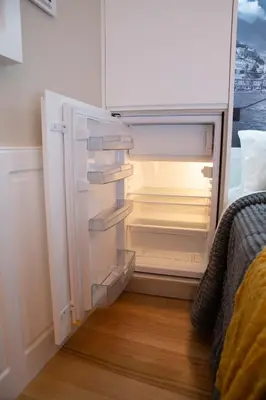 an empty refrigerator with its door open in a room at lita’s House Oporto Bainharia in Porto