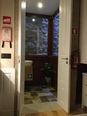 a door leading into a bathroom with a window at lita’s House Oporto Bainharia in Porto