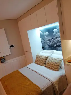 a bedroom with a bed with a picture on the wall at lita’s House Oporto Bainharia in Porto