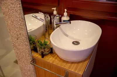 a bathroom with a white sink and a mirror at lita’s House Oporto Bainharia in Porto