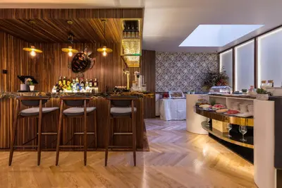 a bar with a counter with bottles of wine at The Convo Porto Hotel & Apartments in Porto