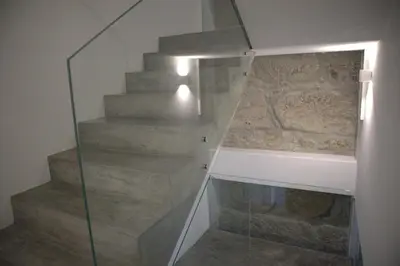a glass stair case with a stone wall at NEW! Colorful and central (9 min-walk to main station) in Porto