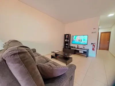 a living room with a couch and a flat screen tv at Private Room at Fatima's in Porto