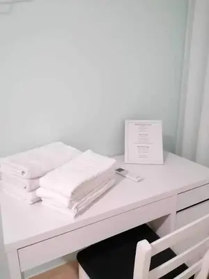 a white desk with a pile of towels on it at Private Room at Fatima's in Porto