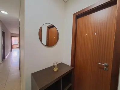 a bathroom with a wooden door and a mirror at Private Room at Fatima's in Porto