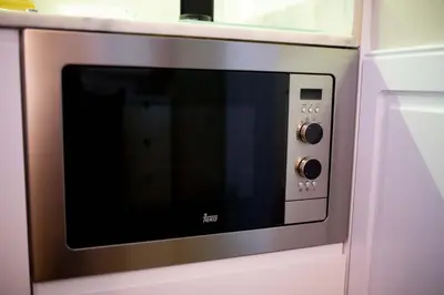 a microwave oven is attached to a kitchen cabinet at Oporto Ana's Studio in Porto