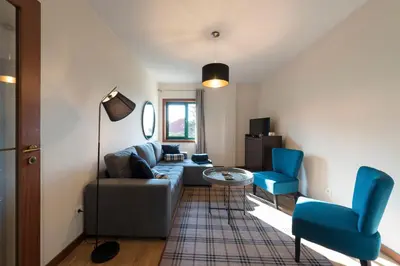 a living room with a couch and two blue chairs at LovelyStay - Homey Feeling Flat w/ Free Parking in Porto