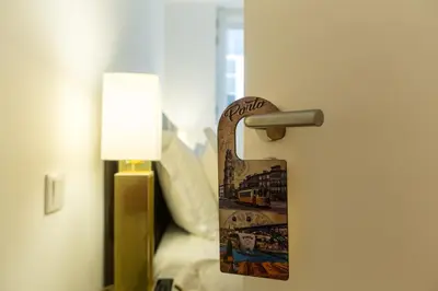 a door with a sign on it in a room at Loft da Sé by Porto City Hosts in Porto