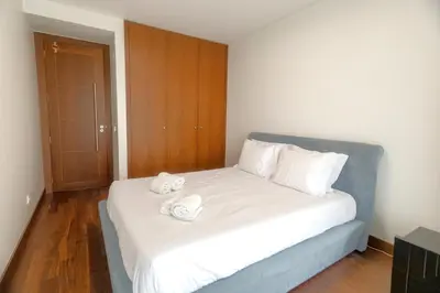a bed with two white towels on top of it at Afurada premium apartment by Porto City Hosts in Vila Nova de Gaia