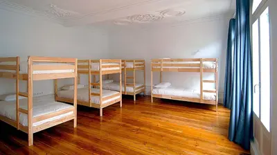 four bunk beds in a room with wooden floors at So Cool Hostel Porto in Porto