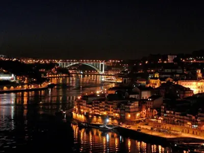 a view of a city at night with a river at ! Free Parking Street ! Ground Floor with Washer! in Porto
