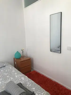 a bedroom with a bed and a mirror on the wall at City Heart Place 1 in Porto