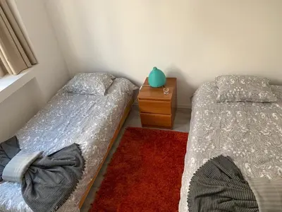a bedroom with two beds and a wooden dresser at City Heart Place 1 in Porto