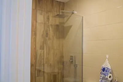 a bathroom with a shower with a glass door at City Heart Place 1 in Porto