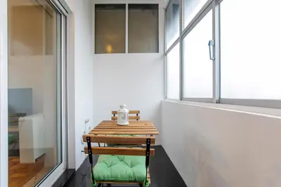 a small table in a room with a window at Casa da Alegria- Downtown by Oporto Soul in Porto