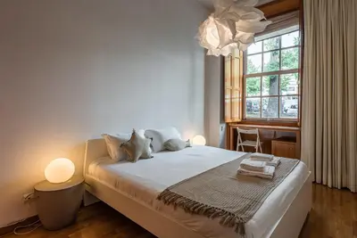 a bedroom with a bed with two stuffed animals on it at GuestReady - City Blossom in Porto