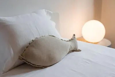 a pillow sitting on top of a bed with two pillows at GuestReady - City Blossom in Porto