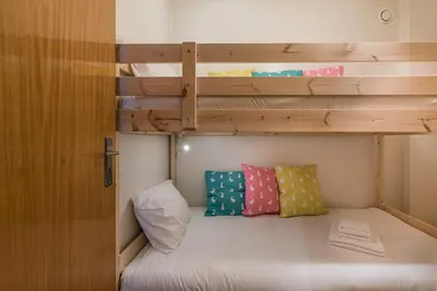 a bunk bed with two pillows in a room at GuestReady - City Blossom in Porto
