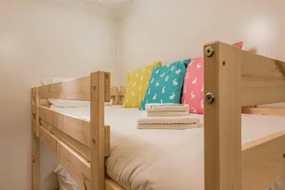 a bedroom with two bunk beds and colorful pillows at GuestReady - City Blossom in Porto