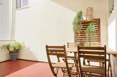 a dining room with a wooden table and chairs at Oporto Classic Pàtio in Porto
