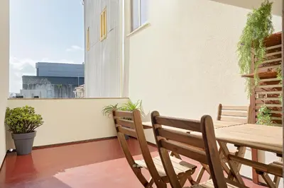 a balcony with two benches and a table and a window at Oporto Classic Pàtio in Porto
