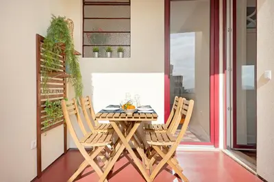a wooden table and chairs on a balcony at Oporto Classic Pàtio in Porto
