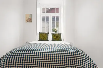 a bed in a white room with a window at Oporto Classic Pàtio in Porto
