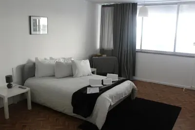 a bedroom with a bed and a window at Silva's Guest House in Vila Nova de Gaia