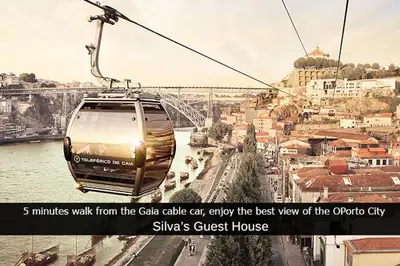 a cable car flying over a city with a bridge at Silva's Guest House in Vila Nova de Gaia