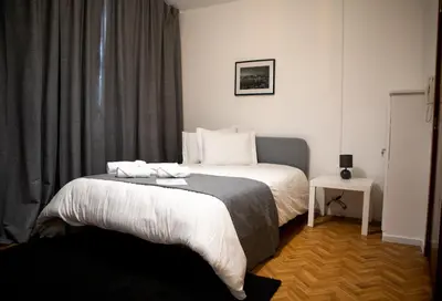 a bedroom with a bed with two towels on it at Silva's Guest House in Vila Nova de Gaia