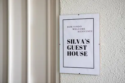 a sign on a wall that reads silas guest house at Silva's Guest House in Vila Nova de Gaia